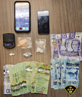 Canadian currency and a digital scale with white powder.