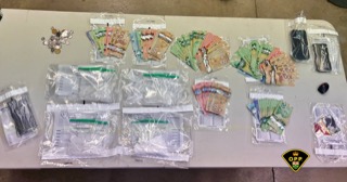 Bundles of Canadian currency and small baggies of a white powdery substance.