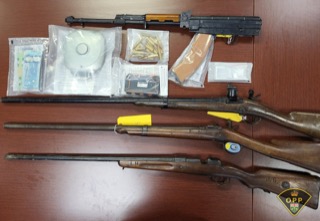 Military-style rifle with ammunition and accessories.
