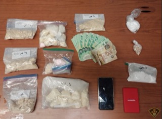 Small bags of white powder and Canadian currency.