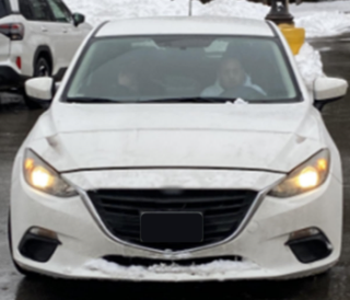 White sedan with headlights and black grille
