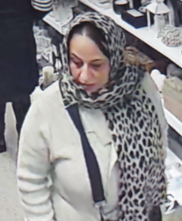 Woman wearing a white sweater and leopard-print scarf