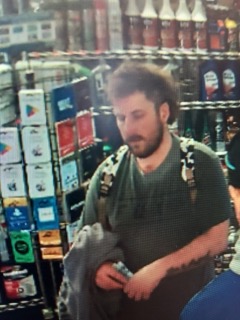 Man with a beard looking at his phone