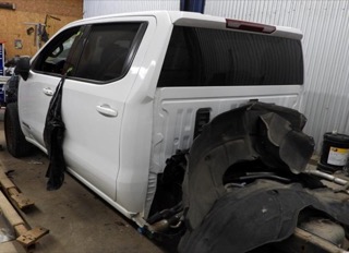 White pickup truck undergoing repairs