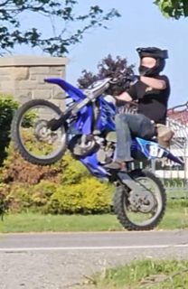 Motorcyclist performing a wheelie