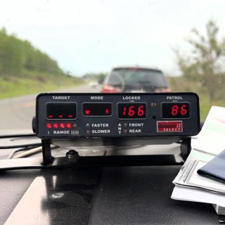 Dashboard-mounted radar display showing 166 and 86