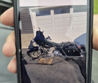 Black Harley-Davidson motorcycle parked in a driveway