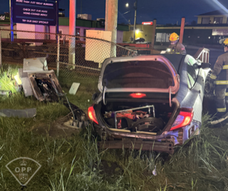 Damaged silver car with deployed airbags