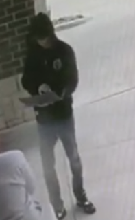 Person holding a rectangular object.