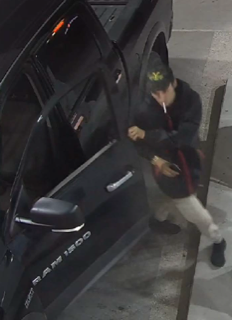 Person exiting a black Dodge Ram 1500