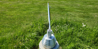 Metal antenna on a grassy lawn