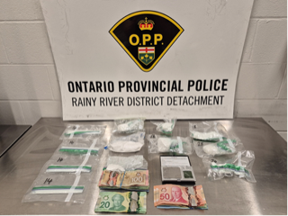 Packages of suspected drugs and Canadian currency on a metal surface.
