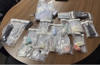 Multiple items in clear plastic bags on a wooden surface.