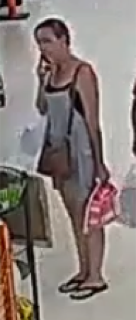 Person wearing a black dress and sandals.