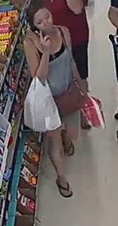 Person carrying a bag in a store.