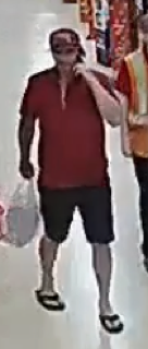 Man in red shirt and black shorts