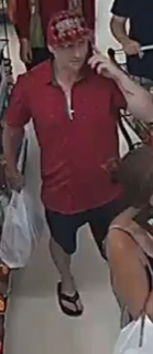 Man in red shirt and black shorts