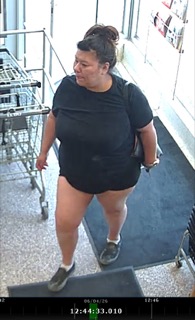 Person walking, black t-shirt, gray sneakers