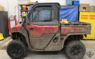 Red utility vehicle with large off-road tires