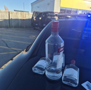 Three bottles of vodka on a car hood