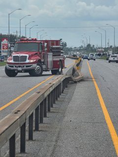 Red fire truck on a highway.