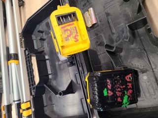 Yellow battery charger with a QR code and text.
