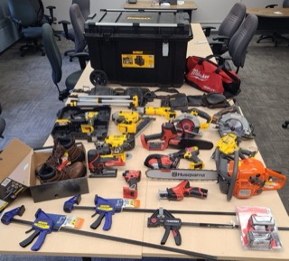 Assorted power tools and accessories on a workbench.