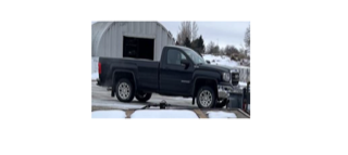 Black pickup truck in snow.