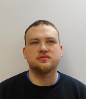 Man with short brown hair and a goatee