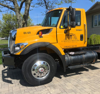 Yellow tow truck with &quot;C. Spence Haulage&quot; logo.