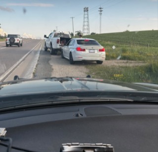 Three vehicles on a highway.