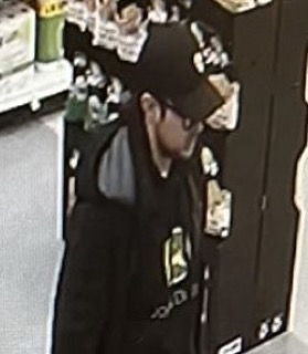 Person wearing a black hoodie and hat