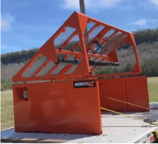 Orange wood chipper on a trailer.