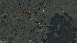Aerial view of forested area with lakes and rivers.