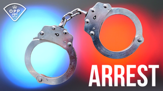 Silver handcuffs against a blurred red and blue background. Arrest.