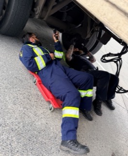 Mechanic working under a truck