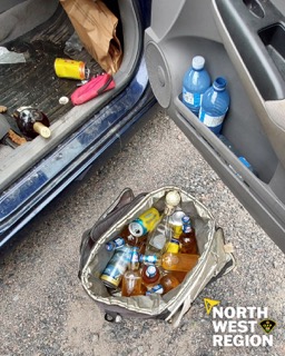 Black trash bag with bottles and cans.